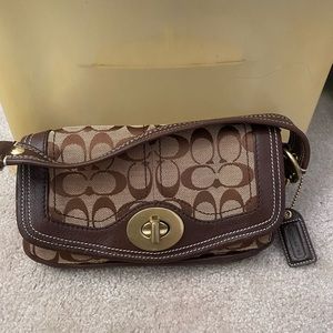 Small brown/tan Coach clutch with strap